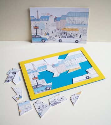 Jeu de puzzle de 26 pièces tiré de l'album "Chez moi" avec son modèle et son support.