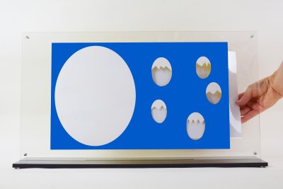 Plexiglass ajouré de l'album "Caché !" avec une page plastifiée pour intéragir avec l'illustration