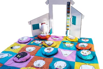 Tapis color&eacute; et ses coussins imprim&eacute;s (&oslash; = 40 cm), plac&eacute;s sur les cases correspondantes pour compl&eacute;ter le damier. Dimensions (Lxl) : 250x250cm.